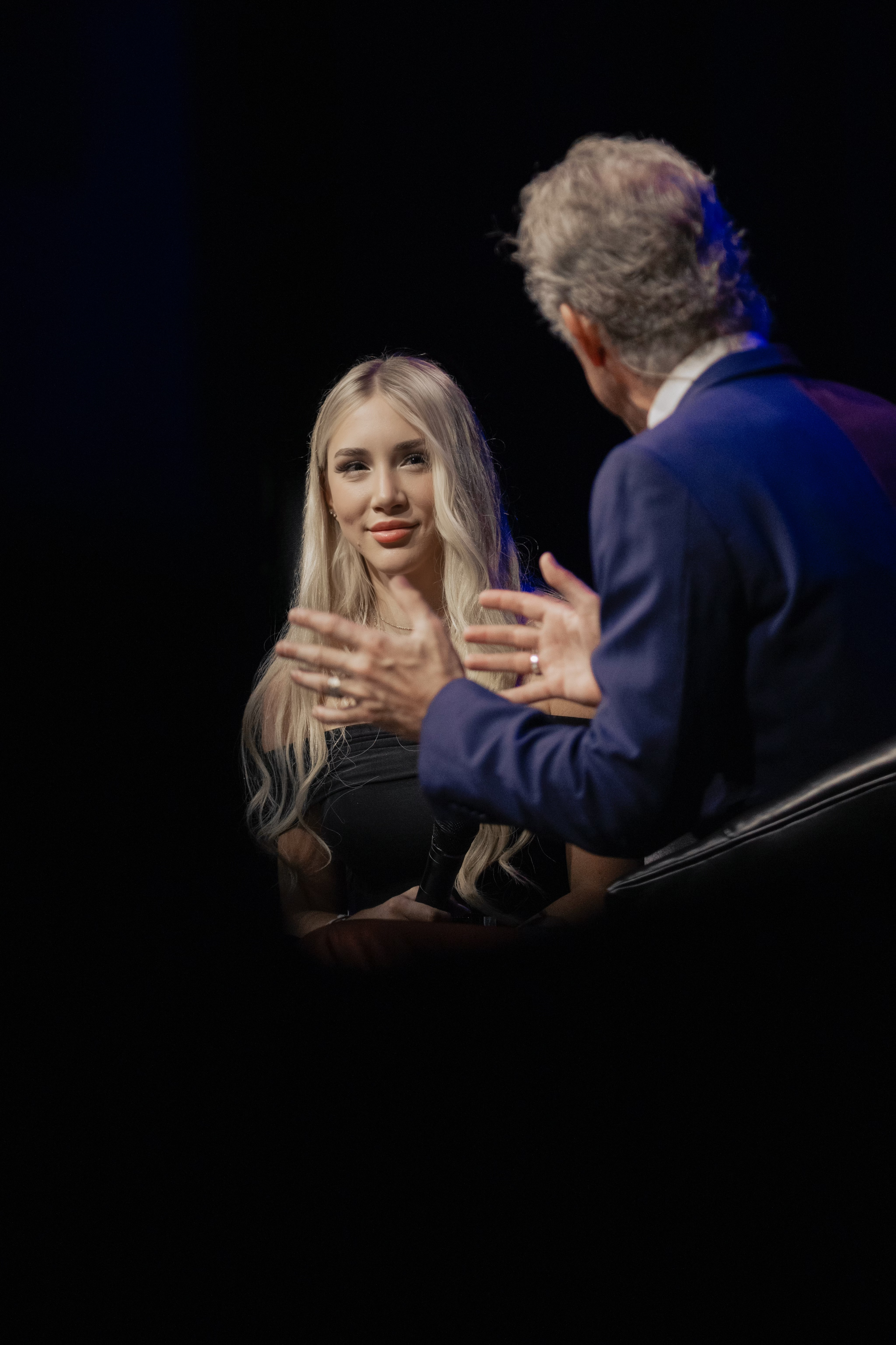 Mikhaila on stage with microphone